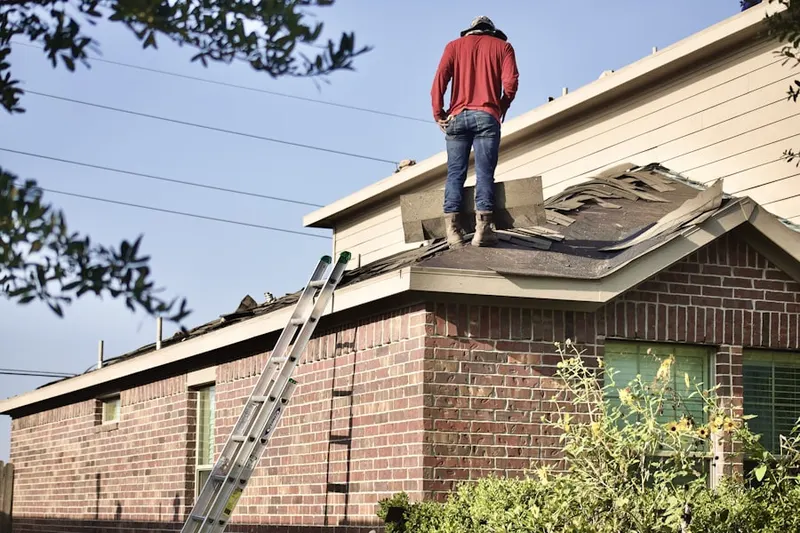 Professional roofer working on a residential roof in San Luis